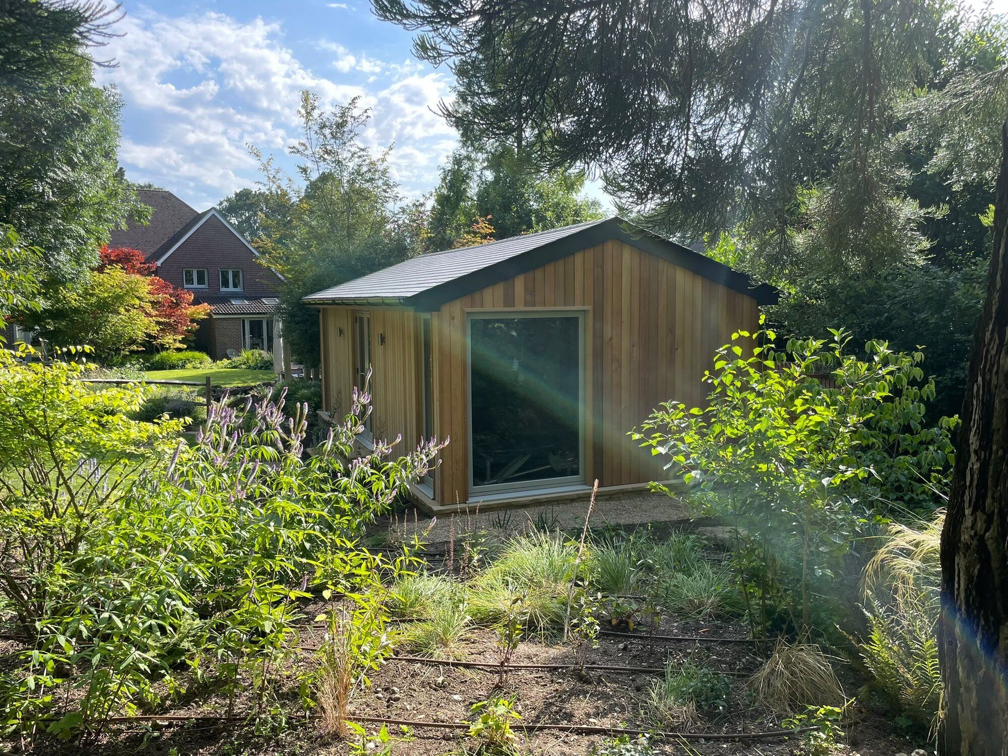 Garden room in mature garden