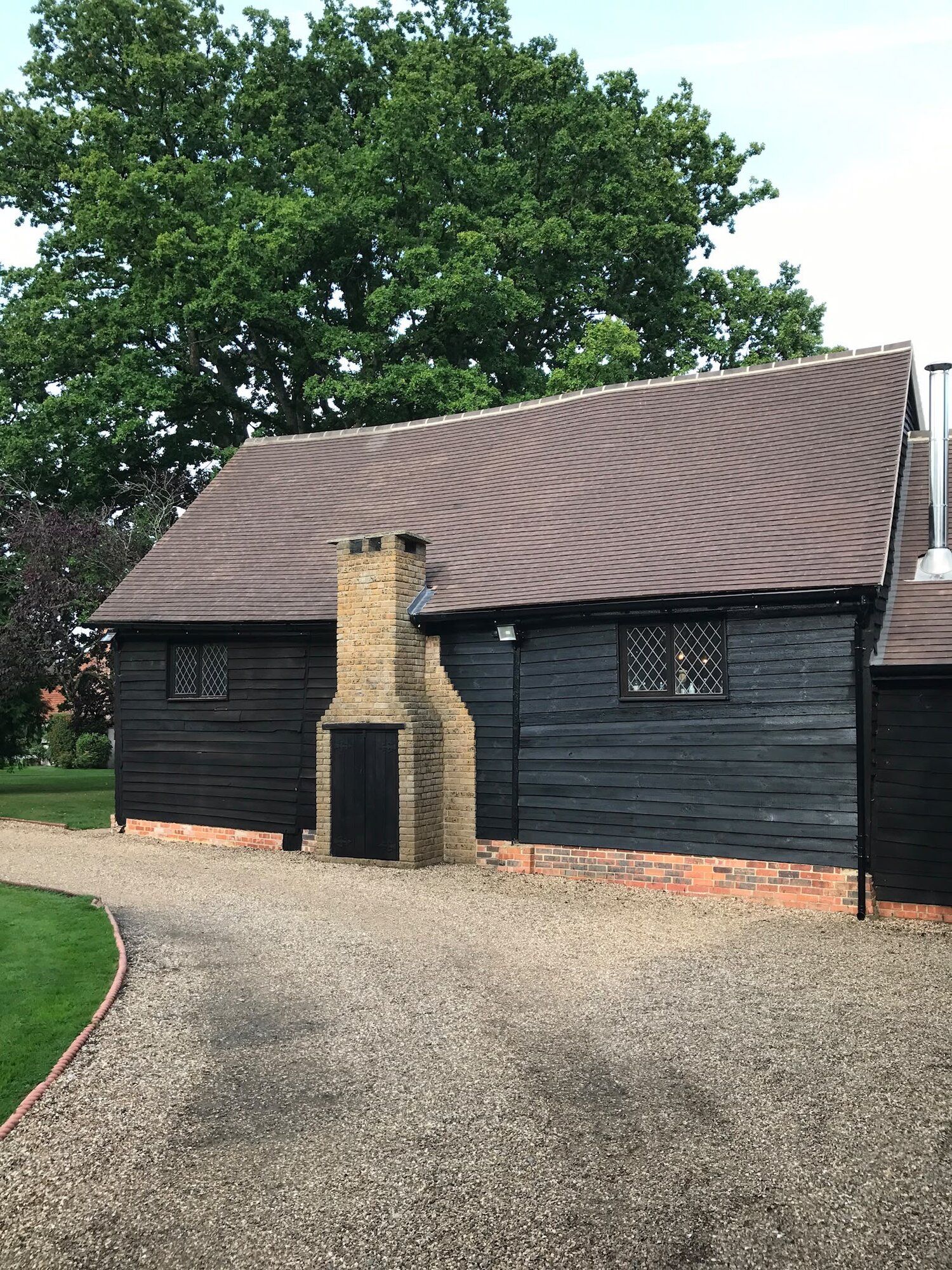 Black timber barn with chimney